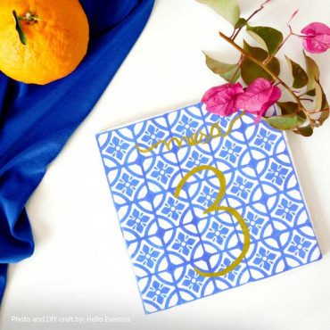 creating intricate designs using a variety of modernist mosaic tile stamps on a colorful piece of fabric