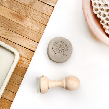 A stamp with your name, text, and information... around a minimalist daisy draw.
