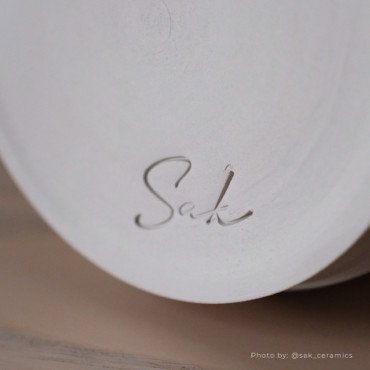 A stamp designed to add a custom logo or mark to pottery and clay pieces A stamp designed to add a custom logo or mark to pottery and clay pieces