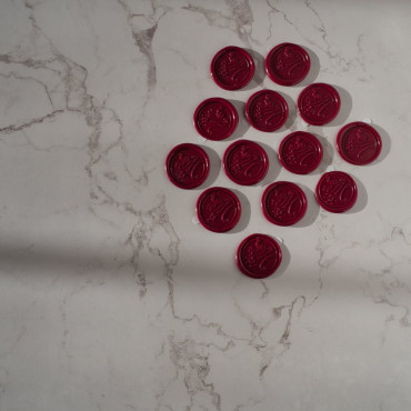 Self-adhesive wax seal applied to a gift box, adding a regal touch to your holiday presents