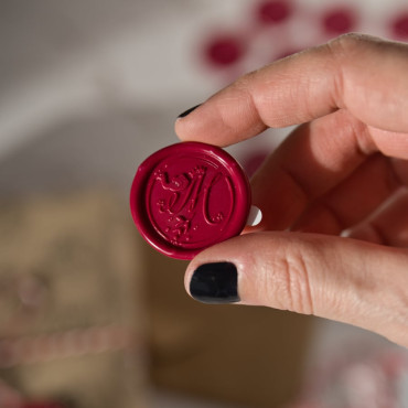 Sealing wax seals with adhesive backing placed on festive labels, ideal for adding a personal touch to gift wrapping