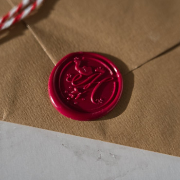 Close-up shot of a wax seal with intricate detail, showcasing the high-quality craftsmanship of each seal