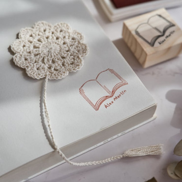 Custom name stamp with a classic open book design for book lovers.