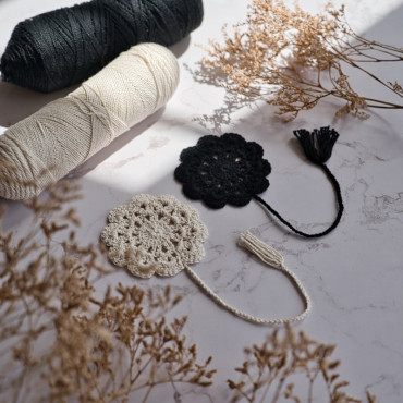 Crochet bookmark in a floral design, available in beige or black, perfect for marking pages with style.