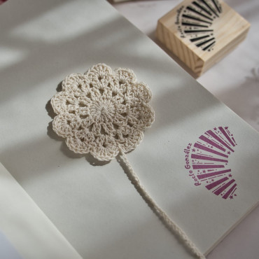 Crochet bookmark with a floral pattern, available in neutral tones for a classic style.