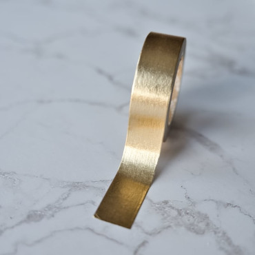 Versatile gold washi tape, easy to cut and peel for creative projects.