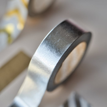 Versatile silver tape for gift wrapping and creative uses.
