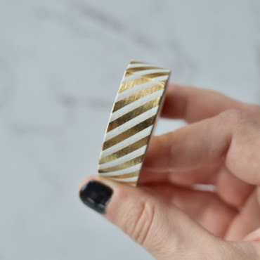 Washi Tape Gold and White Stripes adds a shiny finish to crafts. Perfect for scrapbooking, gift wrapping, and DIY projects.