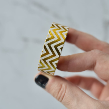 This gold and white zigzag washi tape adds a sleek, geometric touch to gift wrapping, scrapbooking, and DIY projects.