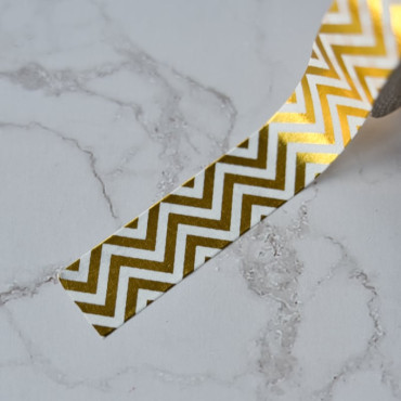 Elevate your DIY crafts and packaging with this gold and white zigzag washi tape, ideal for scrapbooking, gifts, and labels.