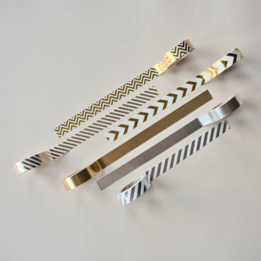 Decorative gold and silver washi tapes with a shiny foil finish, perfect for gift wrapping, scrapbooks, and journals.