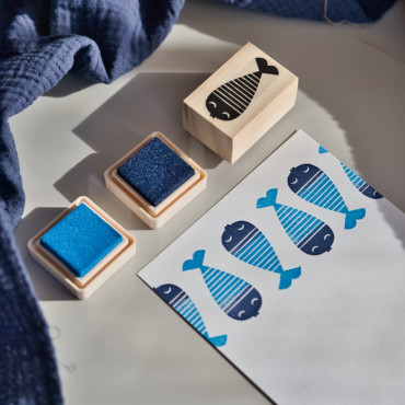This minimalist fish stamp with stripes and a cute face adds a playful touch to any DIY project or craft idea.