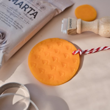 The yellow clay shown in the photos is an air-dry modeling clay that hardens while staying slightly flexible