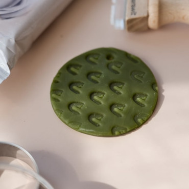The green clay shown in the photo is a special air-dry modeling paste that hardens while staying slightly flexible