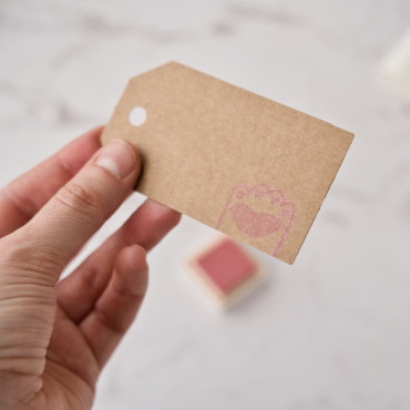 Pale pink ink on top of a kraft label by biterswit