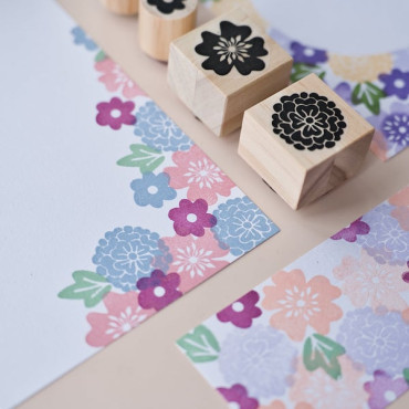 Close-up of a printed floral postcard featuring soft pastel colors and delicate floral details.
