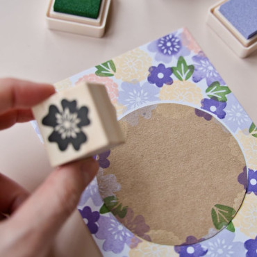 Hand stamping the Sakura floral stamp onto paper, creating a delicate cherry blossom design for your projects.